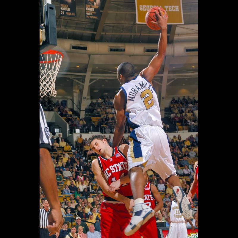 Georgia Tech's #2 Isma'il Muhammad slams one early over NC State's #14 Engin Atsür during play at the Alexander Memorial Coliseum in Atlanta, Georgia, on February 13, 2005. Final score NC State 53 and Georgia Tech 51.