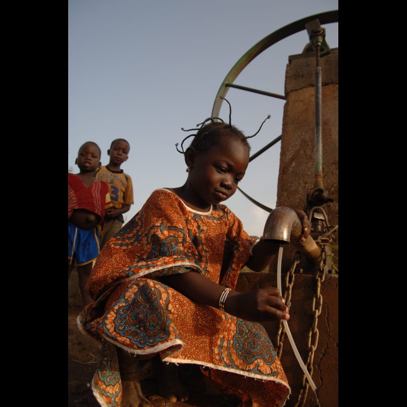 KOUDOUGOU, Burkina Faso Diane Zuma plays with water at a covered well in Koudougou, Burkina Faso. Unlike open wells in the area, this deeper, protected well provides a safer source of drinking water for the community.