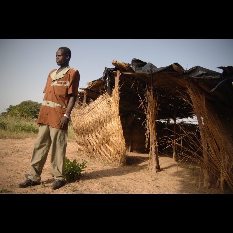 VILI VILLAGE, Burkina Faso Pastor Emanuel Yameogo stands in front of the meeting place for his church in Vili Village, just outside of Koudougou, Burkina Faso. The gathering, known as a "Storying Point," was started by Clarence and Lynn Lance and is made up primarily of children who come to hear Bible stories and grow in their faith.