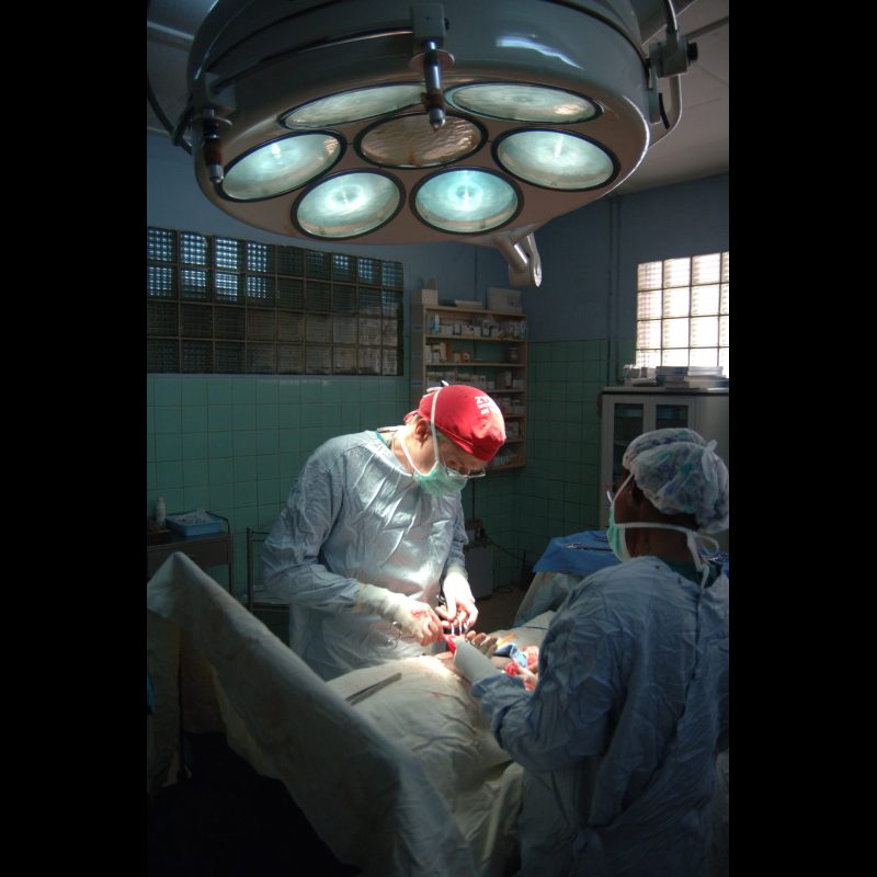 NALERIGU, Ghana — Surgeon Danny Crawley performs a hernia operation in the operating theatre at the Baptist Medical Centre in Nalerigu, Ghana, assisted by Comfort Bawa, a theatre assistant. The hospital serves as a vital surgical and medical resource for communities across northern Ghana.
