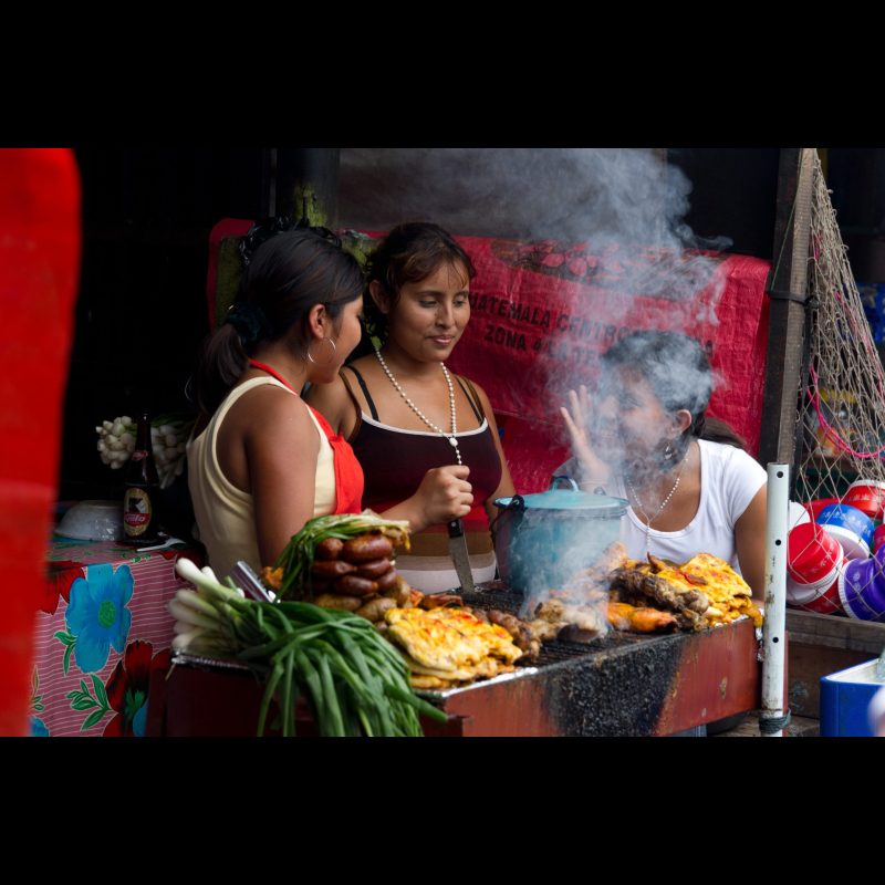 EL CARMEN, Guatemala — Women run a food stand near the Guatemala-Mexico border crossing in El Carmen. The area sees steady foot traffic from migrants and travelers, providing opportunities for small-scale vendors to support their families.