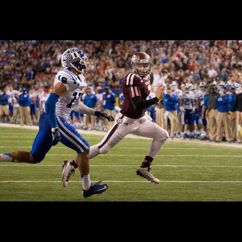 Texas A&M quarterback Johnny Manziel outruns Duke safety Jeremy Cash to the end zone during the Chick-fil-A Bowl.