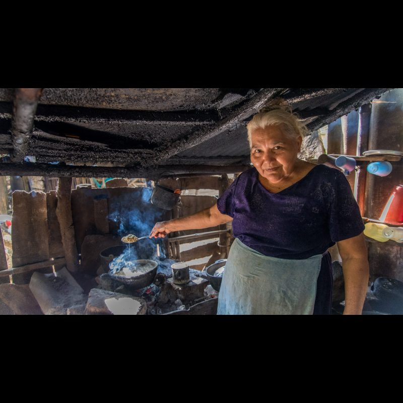 LA CONCHA, Nicaragua — An elderly woman proudly shows her kitchen while preparing a traditional meal in her La Concha, Nicaragua home. Many families in the region cook over wood-fired stoves, preserving customs passed down through generations.