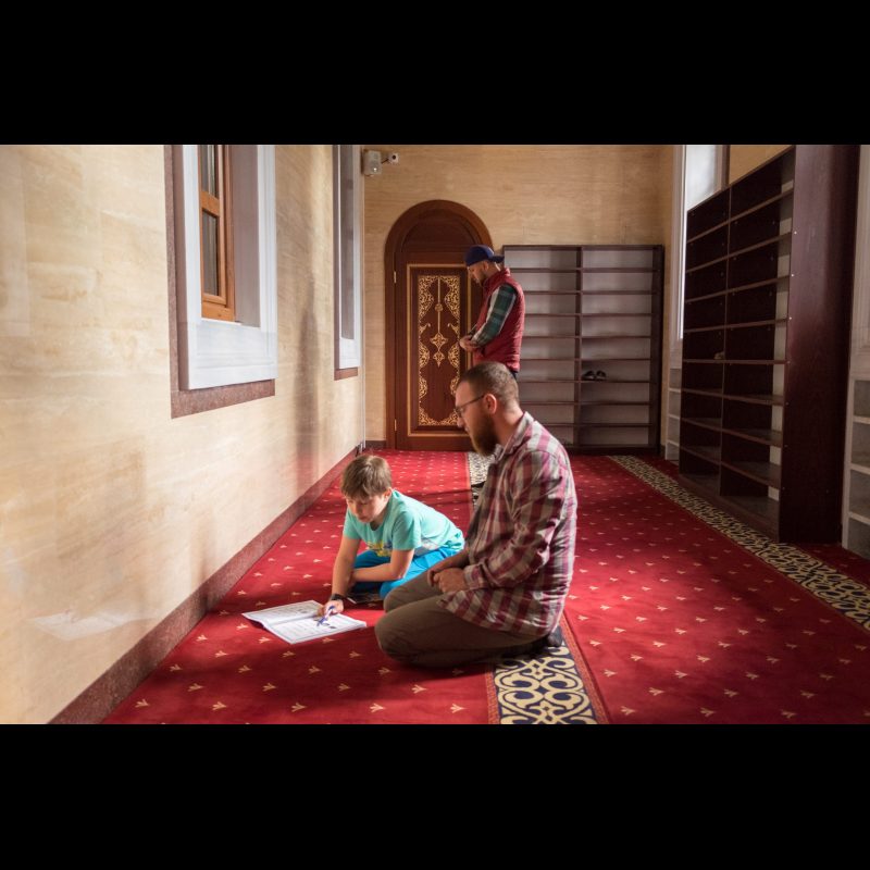 MITROVICA, Kosovo — A father and son pray at a mosque in Mitrovica, Kosovo. The city’s mosques serve as central places of worship and community for many families in this ethnically diverse region.