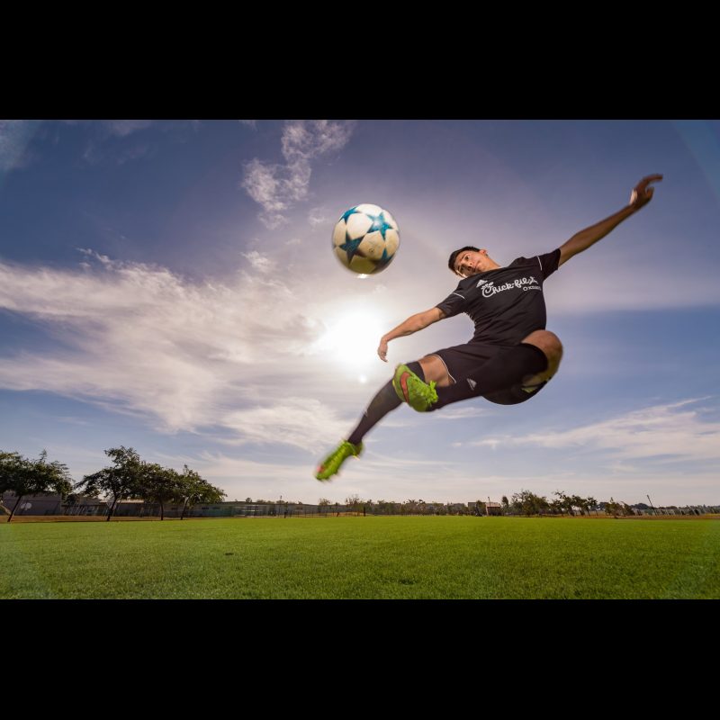 OXNARD, Calif. — An adult man kicks a soccer ball into the air during a game in Oxnard, California. Recreational soccer remains a popular pastime in this coastal community, bringing together players of all ages and backgrounds.