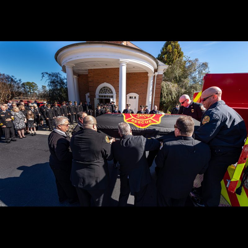 The pallbearers for John Kevin Cash remove his casket to go into the church for the memorial service. Cash served both the Roswell Fire Department and the McDonough Fire Department.