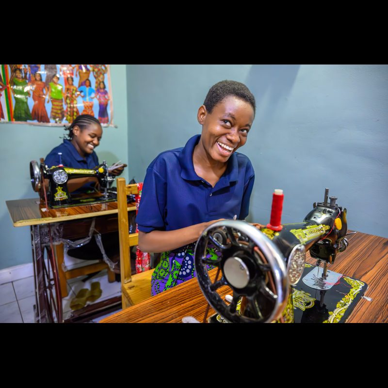Laughter fills the room as two women sew at a Sifa training center in Dar es Salaam, sharing a light moment while learning skills that will help launch their own small businesses. Through its gospel-centered mission, Sifa empowers women to uplift their communities across East Africa.