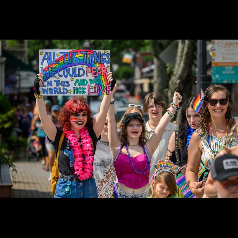 Young participants hold up signs expressing why they are taking part in Roswell’s first-ever Pride Parade on June 21, 2025. The event drew more than 600 people in support of LGBTQ+ rights and inclusion.