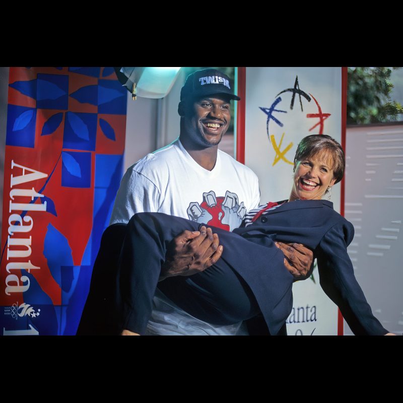 Shaquille O'Neal playfully lifts Katie Couric during a live broadcast of the Today show inside the 1996 Olympic Village on the Georgia Tech campus in Atlanta.
